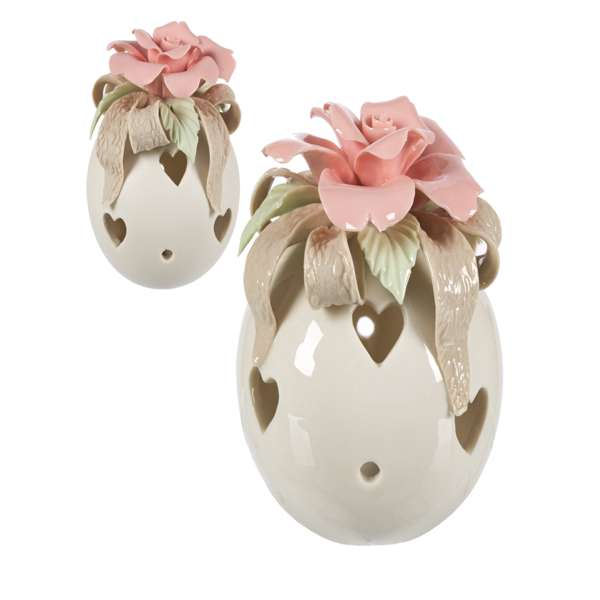 Immagine di una sfera in ceramica bianca con una rosa rosa e una luce LED accesa.